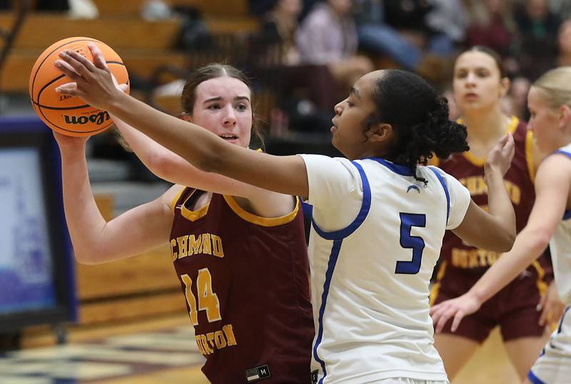 Richmond-Burton's Lilly Kwapniewski looks to pass as she is guarded by Woodstock's Salome Freites-Alvarado during a Kishwaukee River Conference girls basketball game on Wednesday, Jan. 28, 2026, at Woodstock High School.