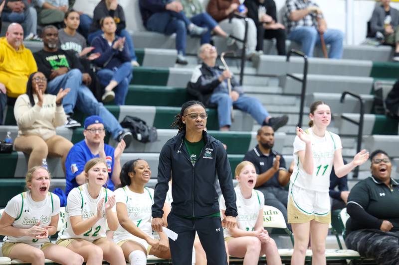 Bishop McNamara head coach Khadaizha Sanders and players celebrate a drawn foul during Bishop McNamara's 60-36 victory over Reed-Custer in the IHSA Class 2A Bishop McNamara Regional semifinals on Monday, Feb. 16, 2026.