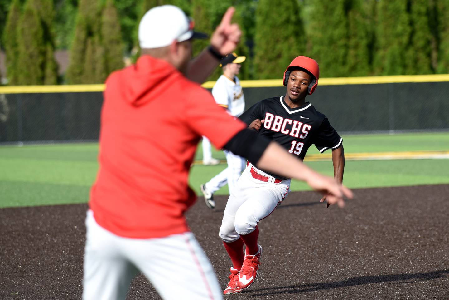 Bradley-Bourbonnais' Byron Sumrall (19) is waved home by coach Brad Schweigert during a game at Herscher Friday, April 24, 2026.