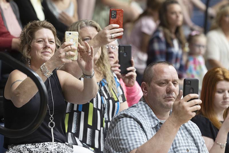 Loved ones take pictures of their graduates at Newman High School Wednesday, May 17, 2023.