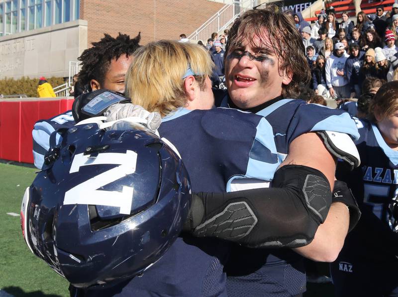 Nazareth's Gabe Kaminski celebrates with a teammate Saturday, Nov. 25, 2023, after their IHSA Class 5A state championship win over Joliet Catholic at Hancock Stadium at Illinois State University in Normal.