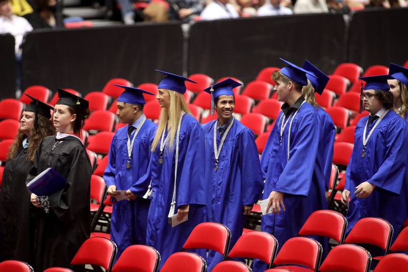 St. Charles North students enter the Northern lllinois University Convocation Center for the school’s annual commencement Ceremony in DeKalb on Monday, May 23, 2022.