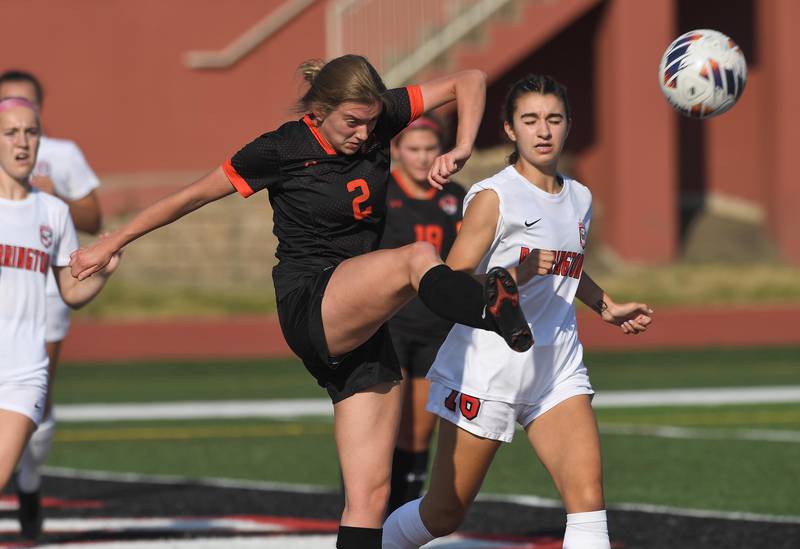 Libertyville’s Mabelle Kosowski kicks the ball past Barrington’s Sarah Sarnowski in the IHSA girls state soccer semifinal game at North Central College in Naperville on Friday, June 2, 2023.