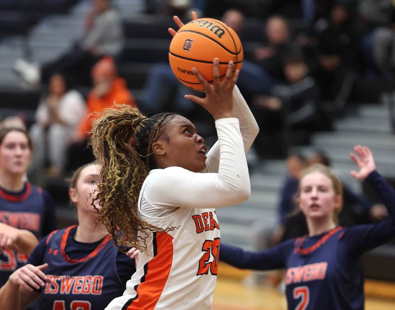 DeKalb's Zora Watts shoots in front of Oswego's Kendall Grant during their game Monday, Jan. 5, 2026, at DeKalb High School.