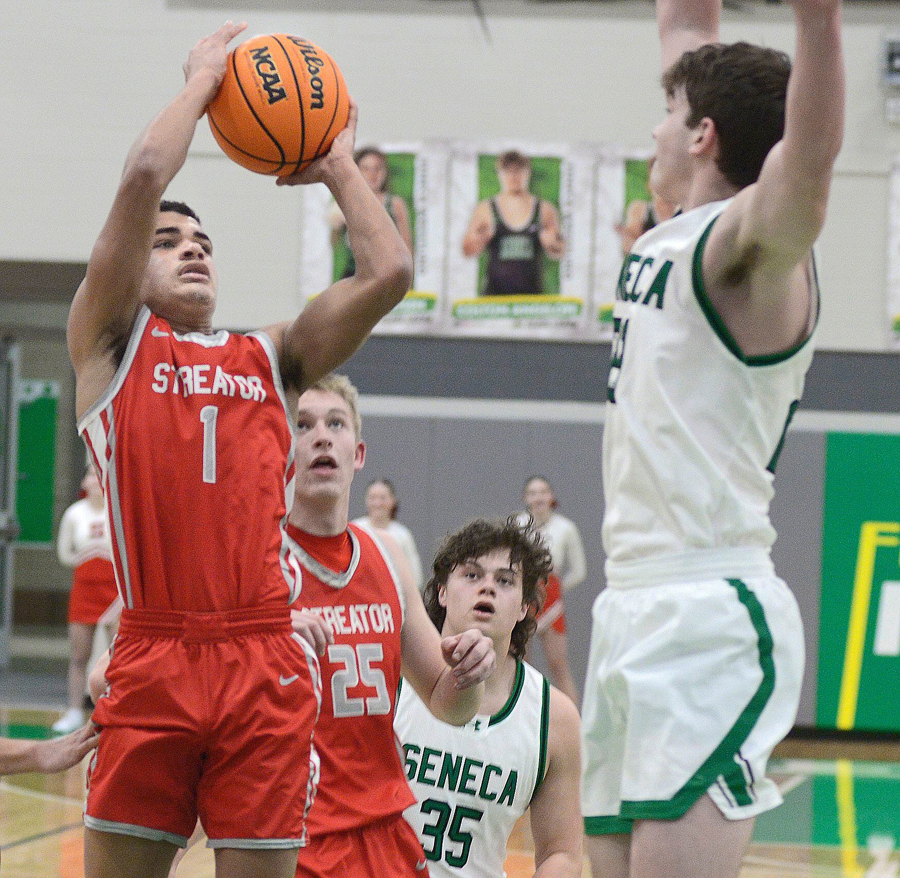 Streator’s Layzeric Moton gets a shot away over the arms of Seneca’s Brady Sheedy in the first period Tuesday at Seneca.