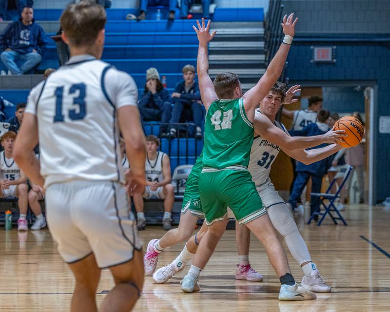 Drew Overocker (31) of Fieldcrest looks to pass ball to teammate Layten Gerdes (13) whilst being trapped by Dwight's defense on Monday, December 15, 2025 at Fieldcrest High School in Minonk.