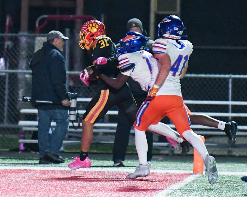 Batavia's Elijah Gonzalez (31) runs in for a touchdown while being defended by Hoffman Estates's JMari Jackson (16) during the first round of playoffs on Friday Oct. 31. 2025, held at Batavia High School.