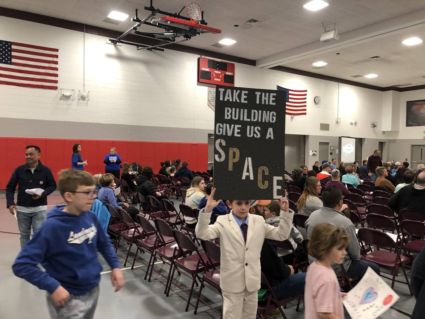Kellen Offermann, a fourth grade student at Landmark School, brought a poster to show his support for his elementary school's program on Monday, April 22, 2024. The district is considering closing the 130 year old building at the end of the 2024-2025 school year.