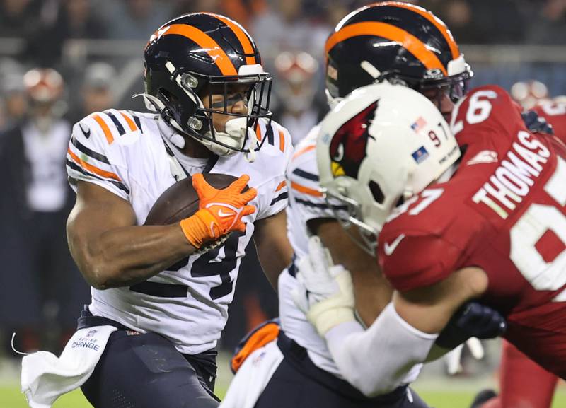 Chicago Bears running back Khalil Herbert finds a hole in the Arizona Cardinals line in the fourth quarter of their game Sunday, Dec. 24, 2023, at Soldier Field in Chicago.