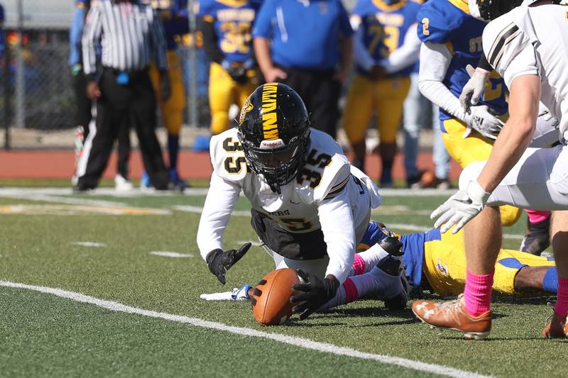 Joliet West’s Micah McNair recovers the fumble against Joliet Central on Saturday.