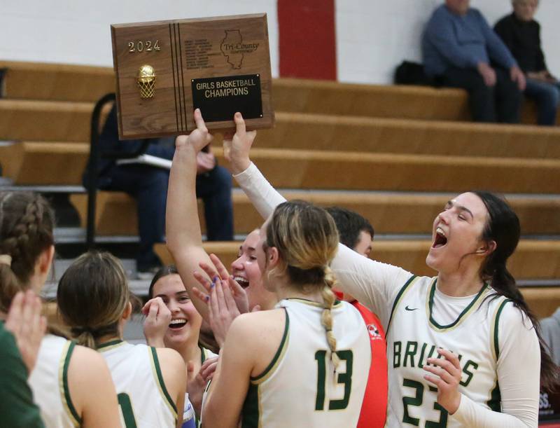 Members of the St. Bede Lady Bruin basketball team hoist the Tri-County Conference Tournament championship plaque after defeating Putnam County on Thursday, Jan. 18, 2024 at Henry-Senachwine High School.