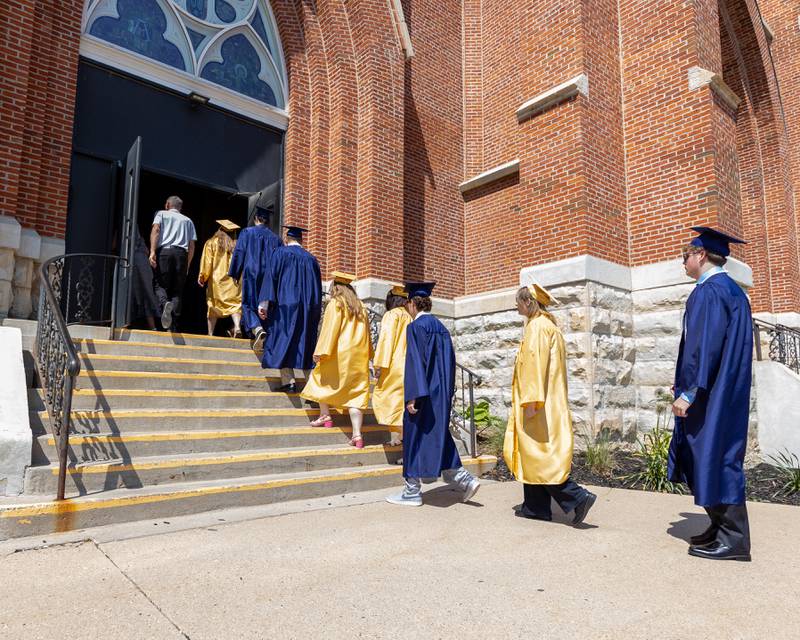 Class of 2026 Marquette Academy Graduates walk up stairs into St. Columba Church before the Graduation Ceremony on May 24, 2026 in Ottawa.