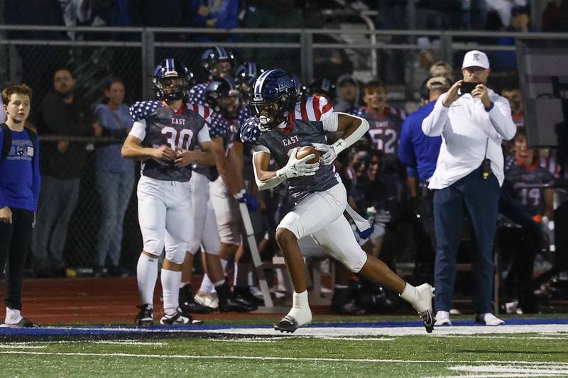 Lincoln-Way East’s Talan White-Hatch turns upfield after a catch for the touchdown against Homewood-Flossmoor on Friday, Sept. 27, 2024 in Frankfort.