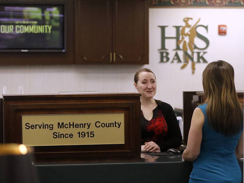 Teller Liz Gezella helps a customer on Thursday, May, 11, 2023 at Home State Bank in Crystal Lake. With a number of bank collapses in recent months, local banks are telling their customers not to worry, as they are not plagued by the same problems that caused those other failures.