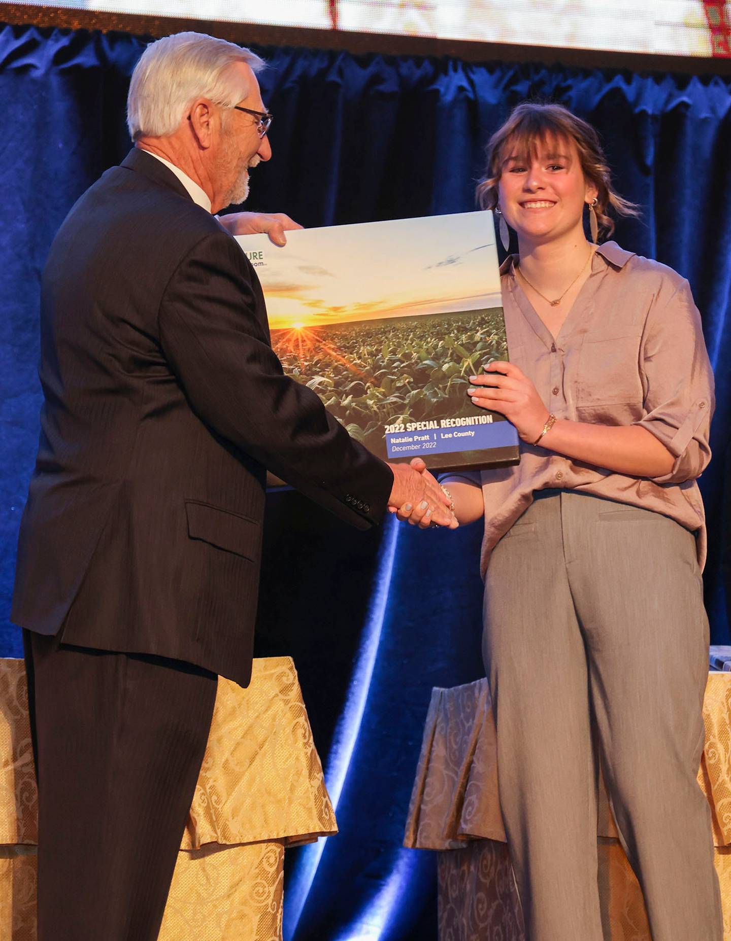 (Left to right); Illinois Farm Bureau president Richard Guebert, Jr., presenting Natalie Pratt with an award recognizing her efforts assisting Illinois Ag in the Classroom with virtual lessons in 2020-2021.