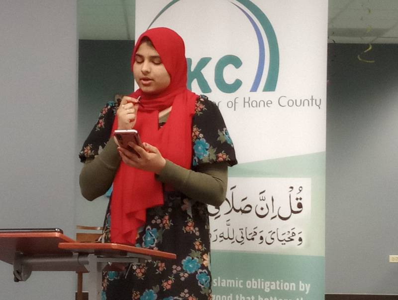 Noor Dogar reads from the Quran in an interfaith ceremony Wednesday at the Islamic Center of Kane County in St. Charles. The event was to share the meaning of fasting during Ramadan and the breaking of the fast at sunset.