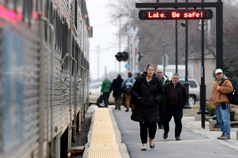 Commuters exit a westbound Metra train from the Chicago direction on Wednesday, March 11, 2020 in Crystal Lake.