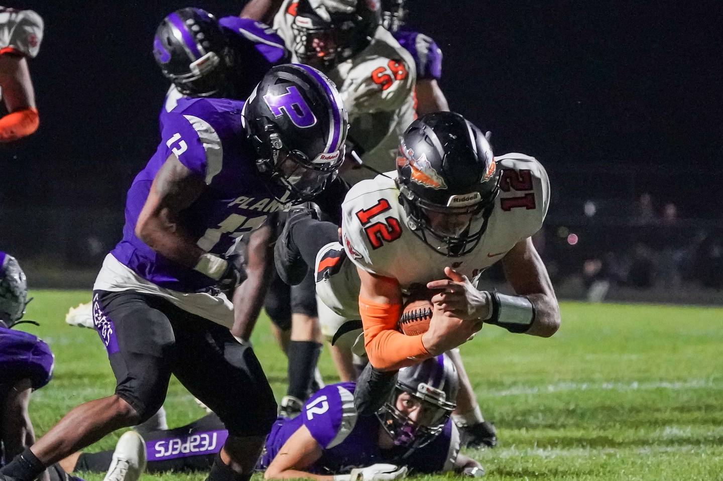 Sandwich’s Brady Behringer (12) dives into the end zone for a touchdown against Plano during a football game at Plano High School on Friday, Sep 13, 2024.