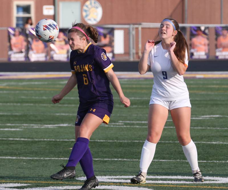 Mendota's Kaley Siemer puts a header on the ball in front of Princeton's Claire Grey during the Class 1A Regional semifinal game on Tuesday, May 9, 2023 at Mendota High School.