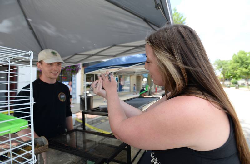 Tim Gy of Westmont and owner of Crepping Critter entertains people including Delilah Durbin of Lockport with  his snakes, lizards and Praire Dog during the Taste of Westmont Saturday July 12, 2025.