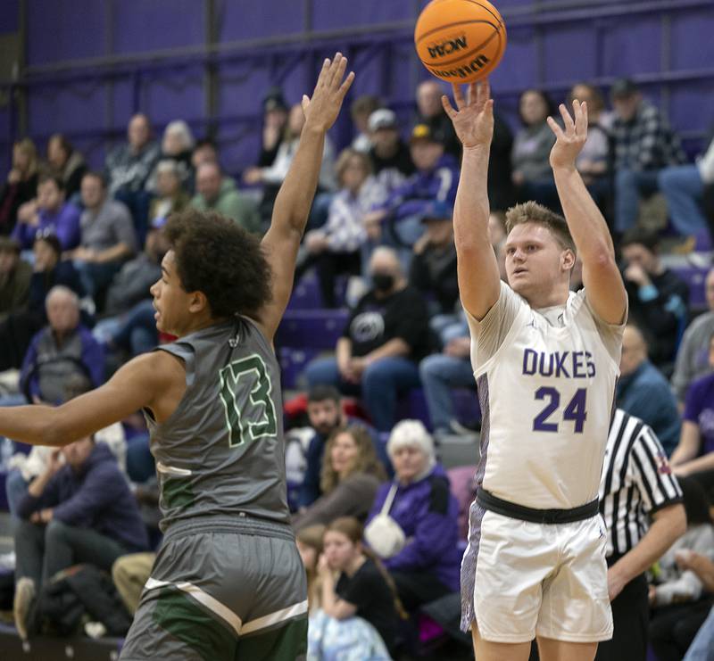 Dixon’s Eli Davidson puts up a three point shot against Plainfield Central’s Phoenix Jones Friday, Jan. 3, 2025, at Dixon High School.
