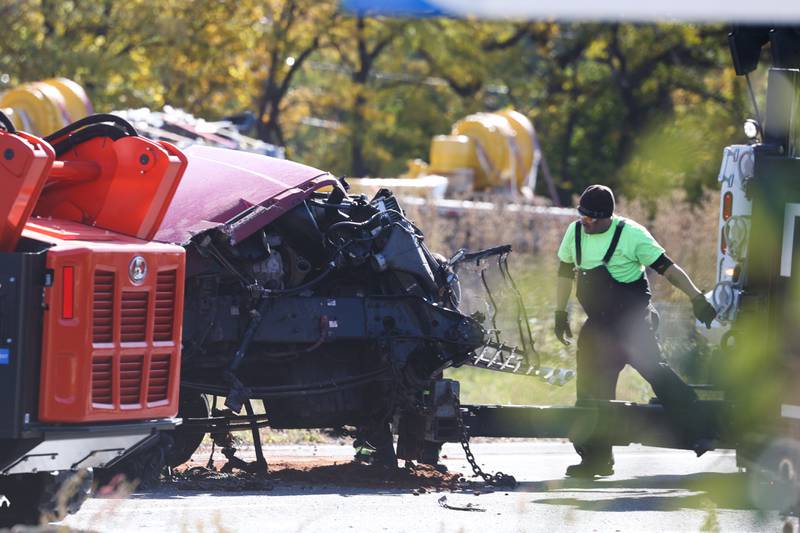 A tow truck works to remove a totaled semi-truck. A crash involving two semitrailers shutdown down southbound I-55 as diesel fuel, water bottles and soybeans covered all lanes of Interstate 55 south of the I-80 interchange early Wednesday morning.