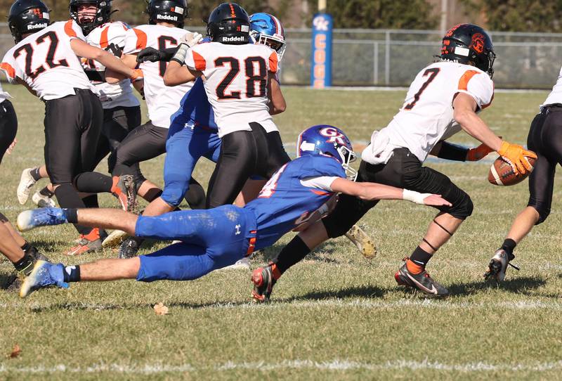 Genoa-Kingston's Connor Grimm trips up Elmwood quarterback Bo Windish during their first round playoff game Saturday Oct. 29, 2022, at Genoa-Kingston High School.