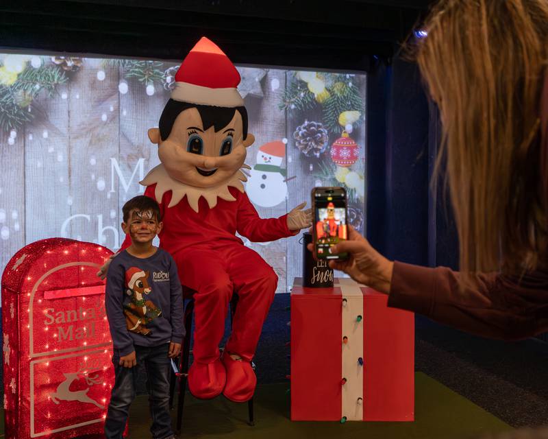 Levi Pyszka poses for photo with Elf at the annual Christmas in the Valley on Saturday, November 15, 2025 at the Tee Box in Spring Valley.