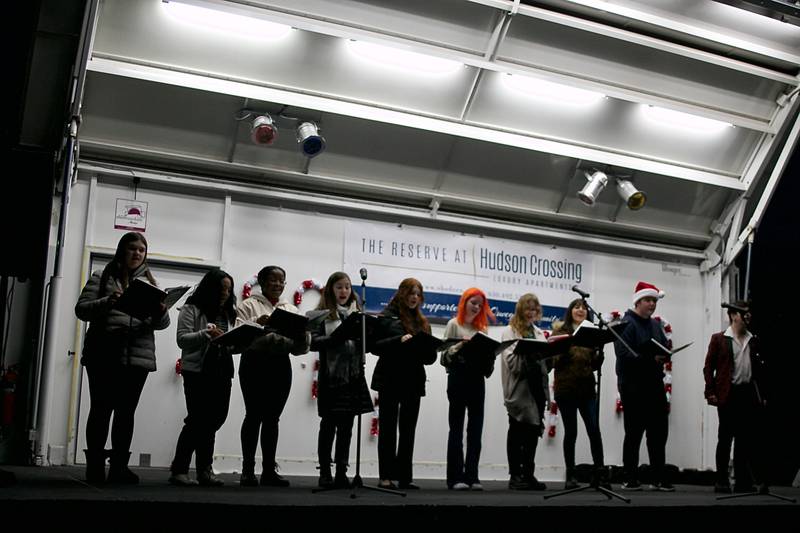 Oswego East High School's Spotlight Choir entertained with holiday tunes at Oswego's Christmas Walk on Dec. 3 along Main Street.