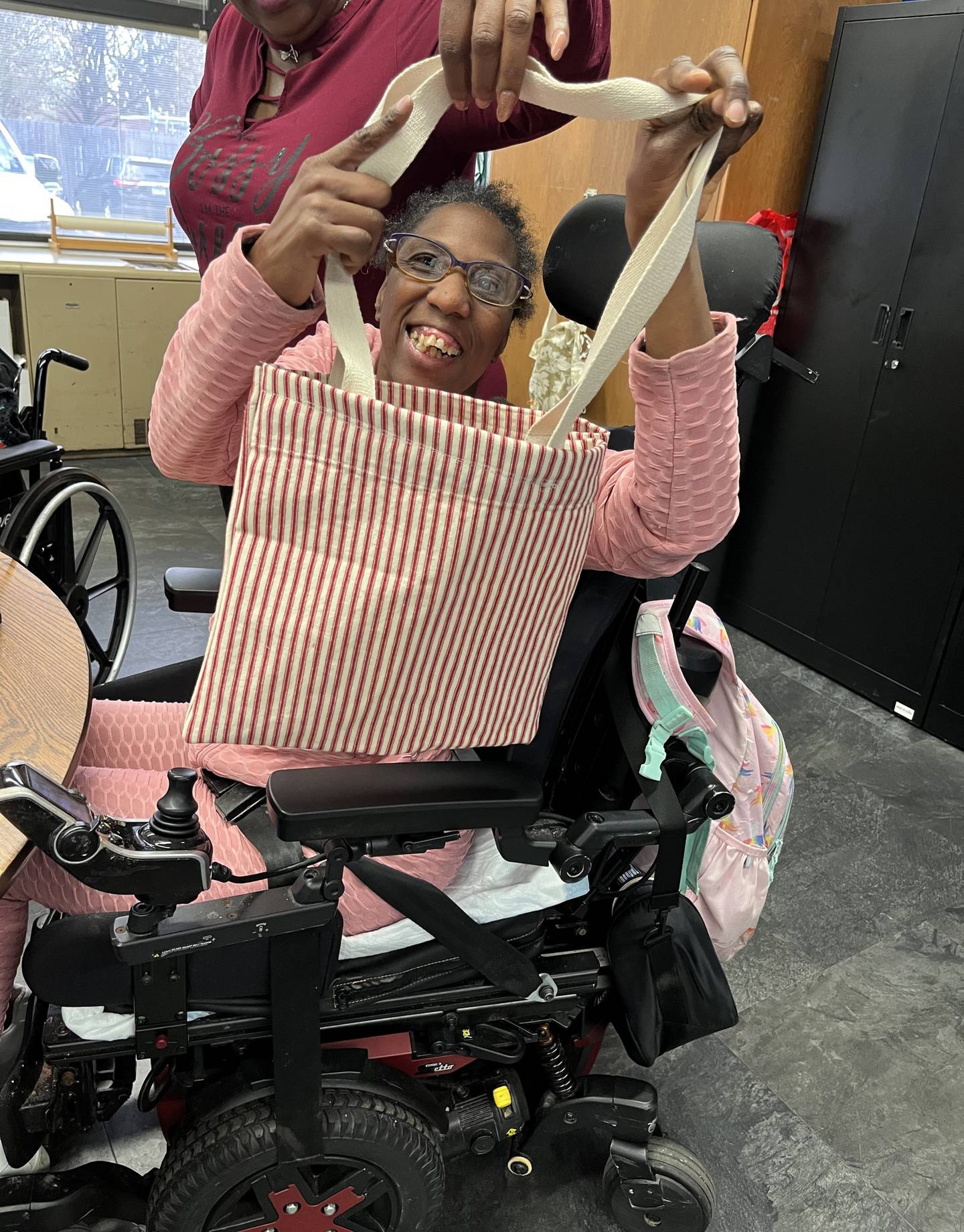Antoinette Rivers holding up her very first Sew What?! project at  UCP-Center for Disability Services in Joliet.