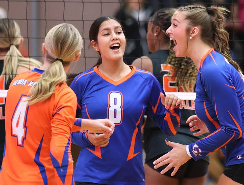 Genoa-Kingston players celebrate a point during their match Wednesday, Sept. 10, 2025, at DeKalb High School.