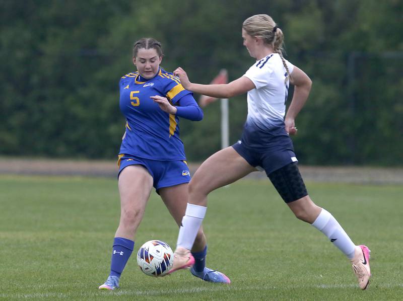 Johnsburg's Elaina Moss tries to get the ball as it is kicked away by Harvest Christian Academy's Ellie Semerau during the Class 1A Marian Central Girls Soccer Regional Championship match on Tuesday, May 20, 2025, at Marian Central High School in Woodstock.