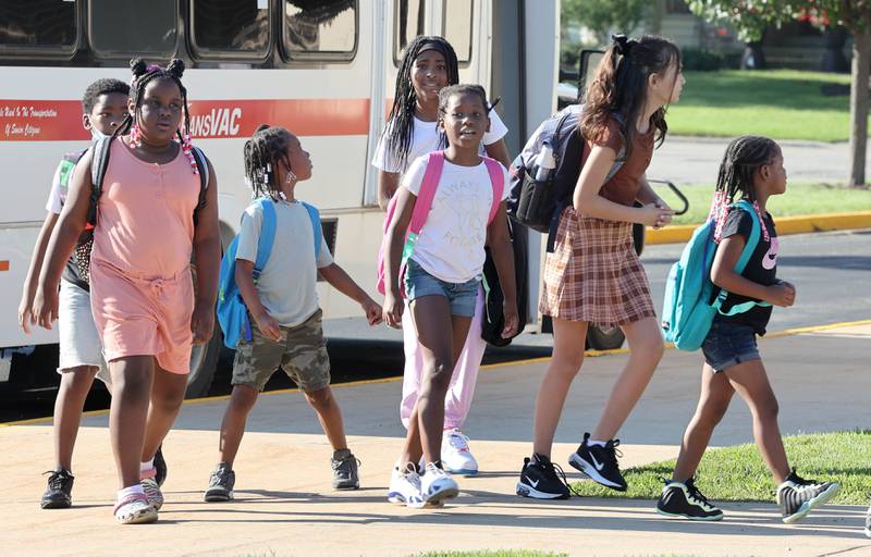 Students arrive Thursday, Aug. 18, 2022, for the first day of school at Tyler Elementary in DeKalb.