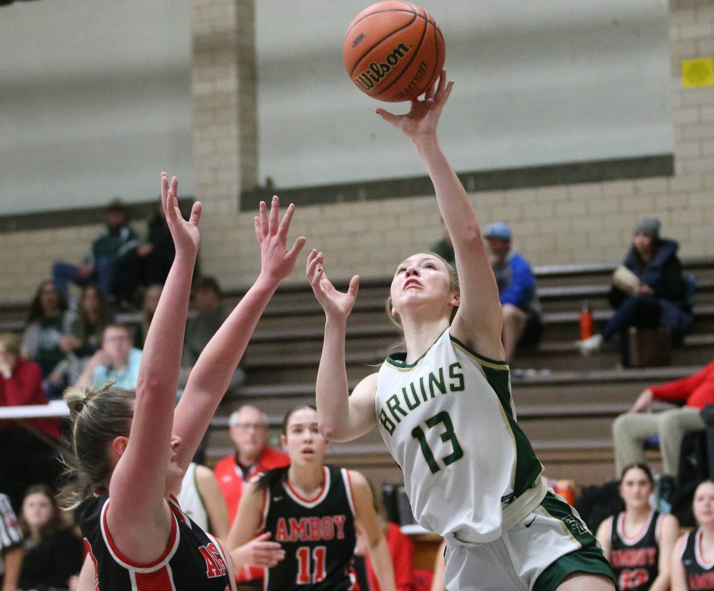 St. Bede's Ashlyn Ehm lets go of a shot over Amboy's Emily Sachs during the Class 1A Regional final game in February 2024 at Marquette High School.