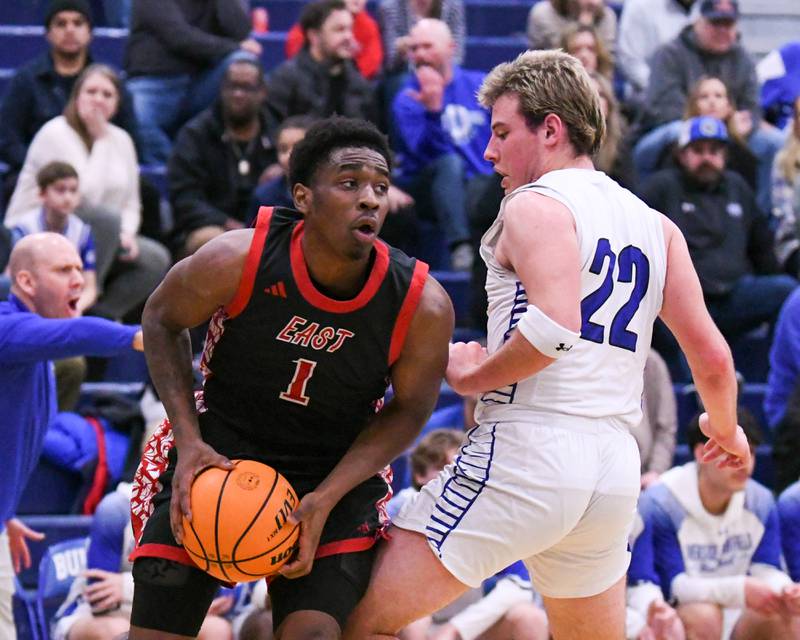 Glenbard East's Keenan House (1) tries to get around Riverside-Brookfield's defender Benjamin Biskupic (22) during the game on Tuesday Feb. 3, 2026, held at Riverside-Brookfield High School.