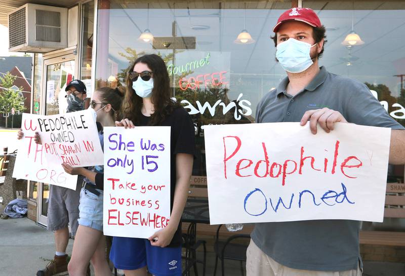 Protesters picket in front of Shawn's Coffee Shop in Sycamore Friday to inform the public of allegations that the owner, Shawn Thrower, committed misdemeanor battery against a 15-year-old employee. Thrower allegedly bit and inappropriately touched the employee.