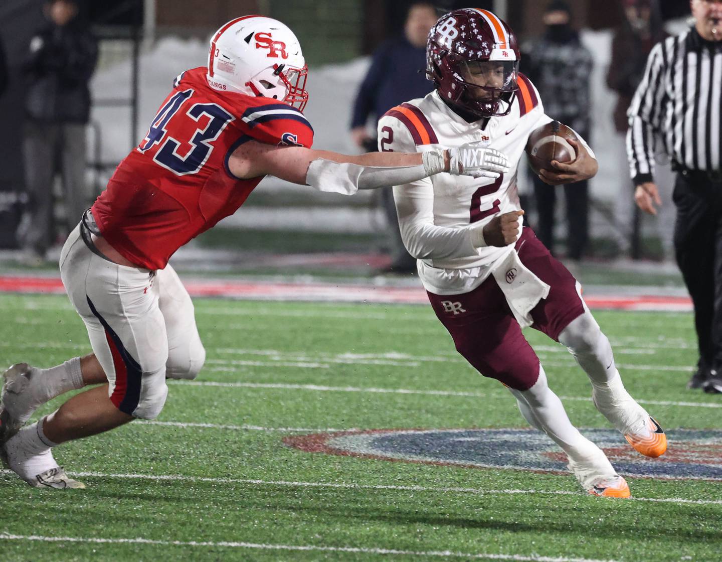 Brother Rice's C.J. Gray gets by St. Rita's Jack Schapendonk Wednesday, Dec. 3, 2025, during their IHSA Class 7A state chamionship game in Huskie Stadium at Northern Illinois University in DeKalb.