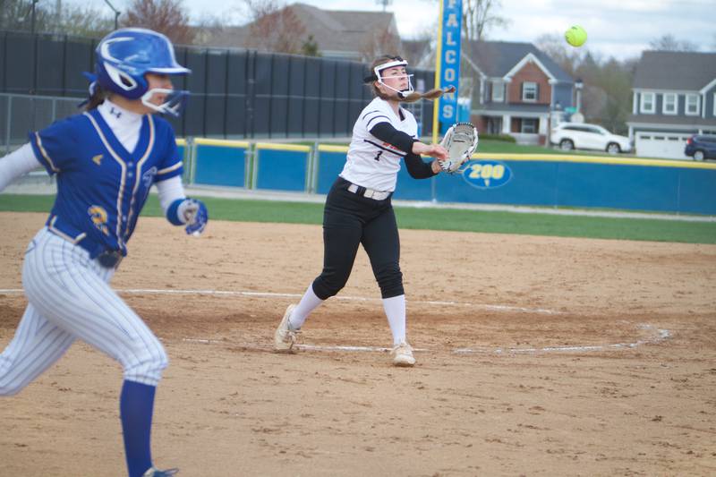 St. Charles East's Makayla Van Dinther throws to first before Wheaton North's  Alyssa Savenok on Monday, April 21, 2025 In Wheaton.
