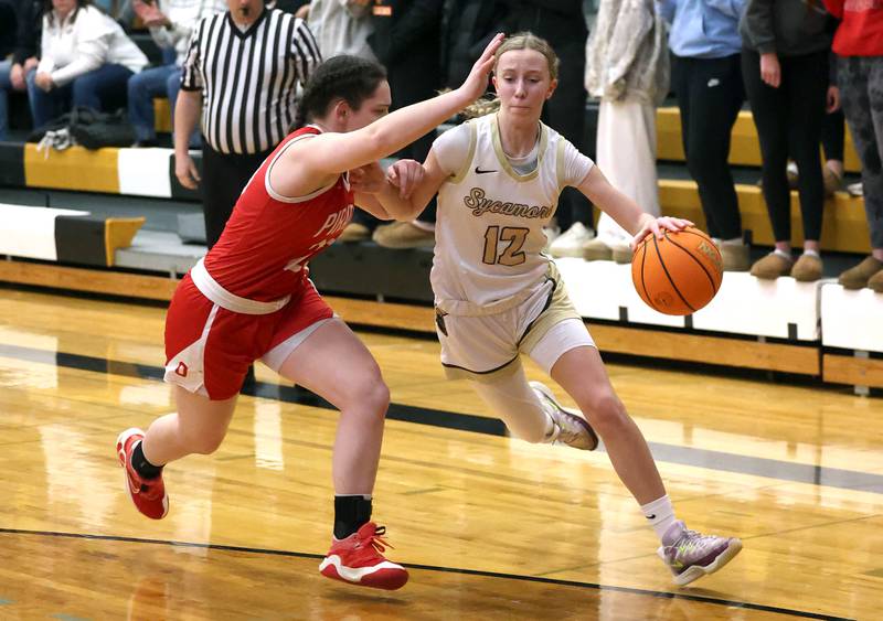 Sycamore's Sadie Lang goes to the basket against Ottawa's Mary Stisser during their game Friday, Jan. 10, 2025, at Sycamore High School.