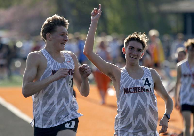 McHenry’s Myles Wagner and Nate Martin finish together in the 3200 meters run on Thursday, April 23, 2026, during the McHenry County Track and Field Meet at McCracken Field in McHenry.