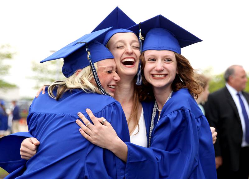 (Left to right) St. Charles North graduates Morgan Zyrek, Maddy Gaber and Makenzie Thomas pose for a photo before the school’s commencement ceremony at the Northern Illinois University Convocation Center in DeKalb on Monday, May 23, 2022.