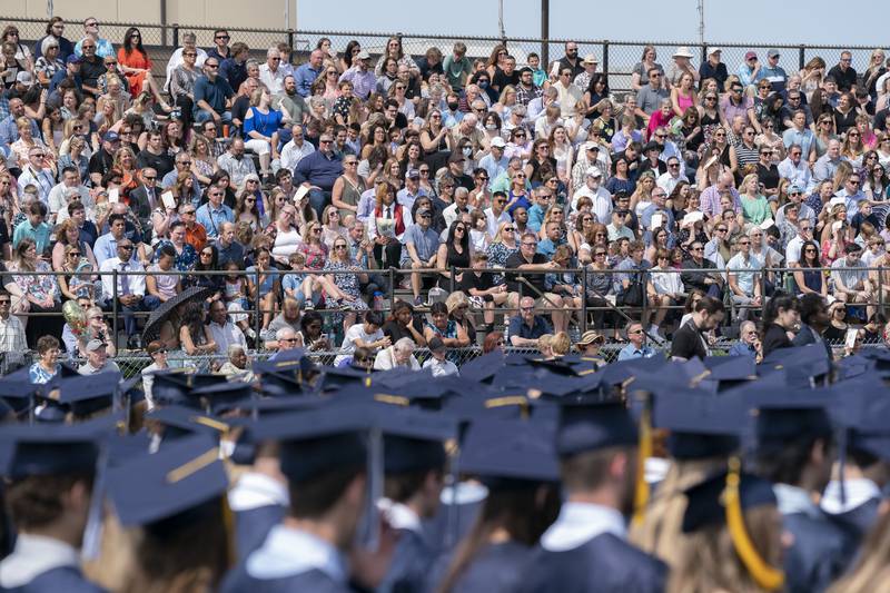 Family and friends watch from the bleachers during a graduation ceremony for the class of 2022 on Saturday, May 14, 2022, at Cary-Grove High School in Cary.