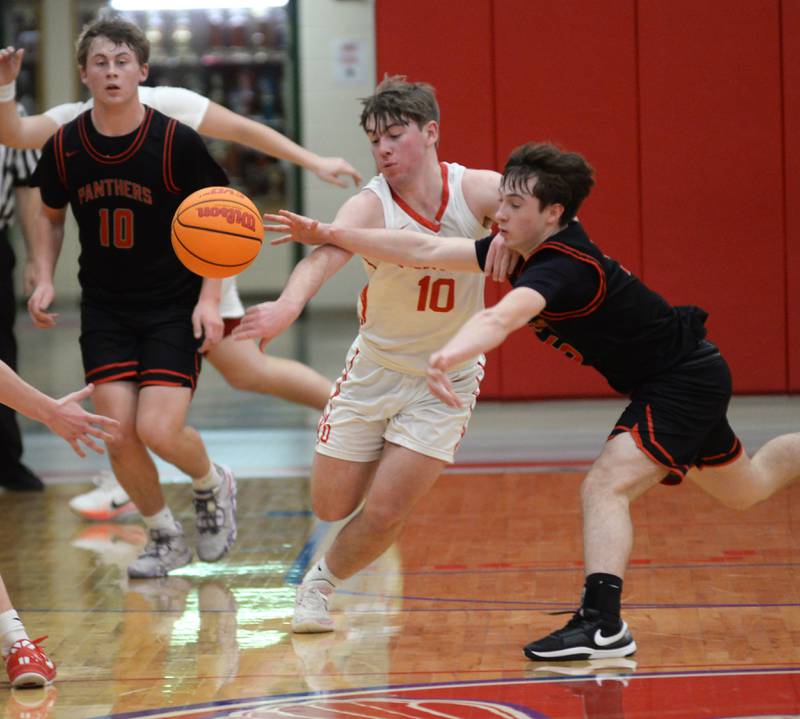 Erie-Prophetstown's Max Milem (5) and Oregon's Keaton Salsbury (10) reach for a loose ball on Monday, Feb. 24, 2025 in 2A regional action at the Blackhawk Center in Oregon.