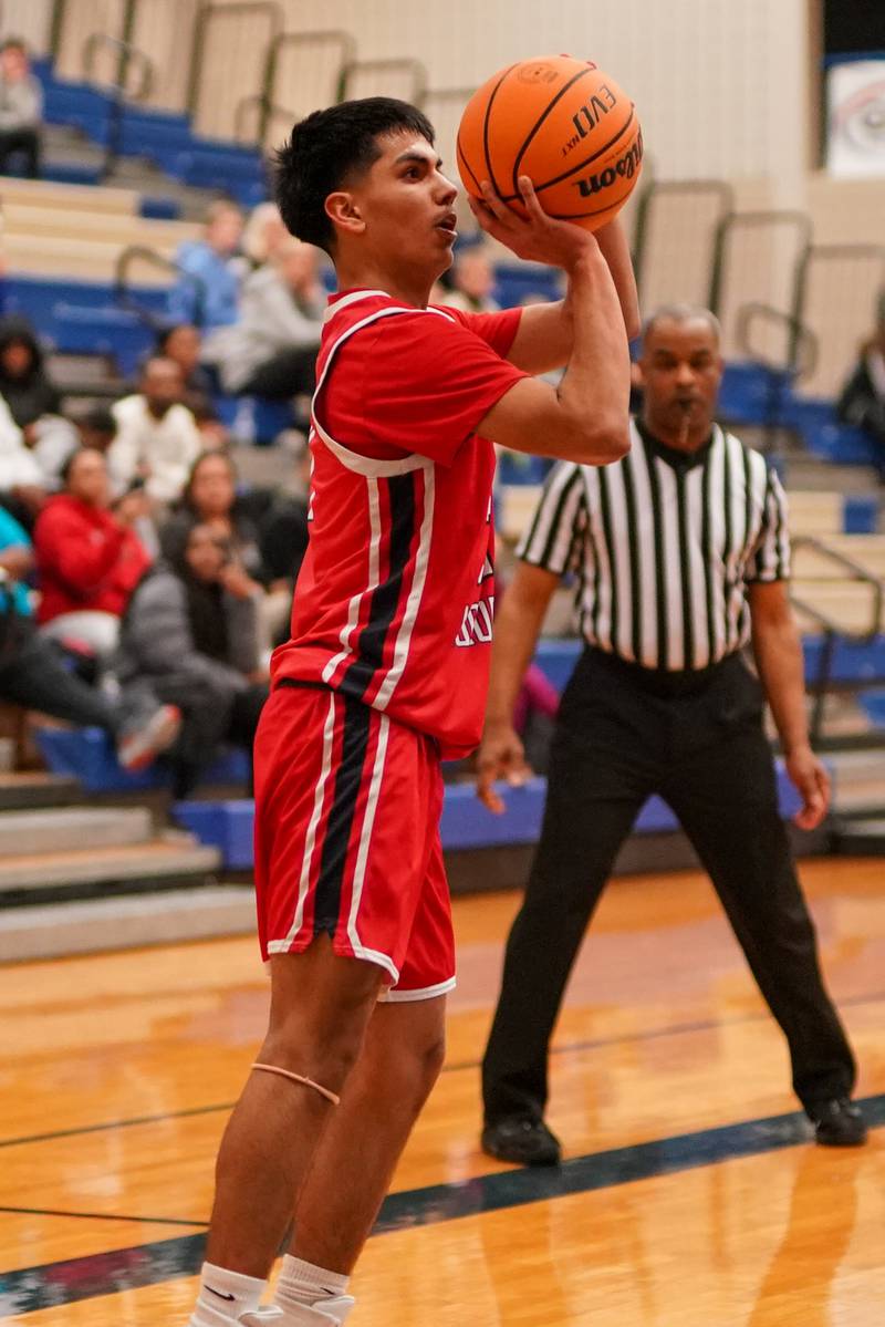 West Aurora's Abe Martinez (21) shoots a three pointer  during a MLK Day of Hoops basketball game against Geneva at Geneva High School on Monday, Jan. 20, 2025.