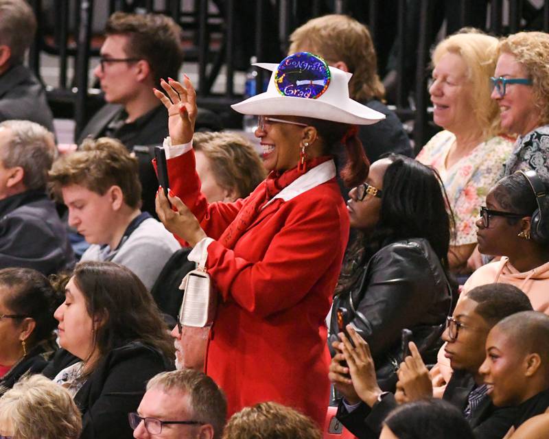 A Northern Illinois University commencement attendee waves to a graduate during the graduatin ceremony on Saturday May 9, 2026, held at the Convocation Center in DeKalb.