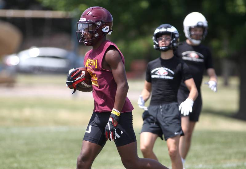 Montini’s Donovan Olugbode catches a pass during a 7 on 7 tournament at St. Charles North High School on Thursday, June 30, 2022.