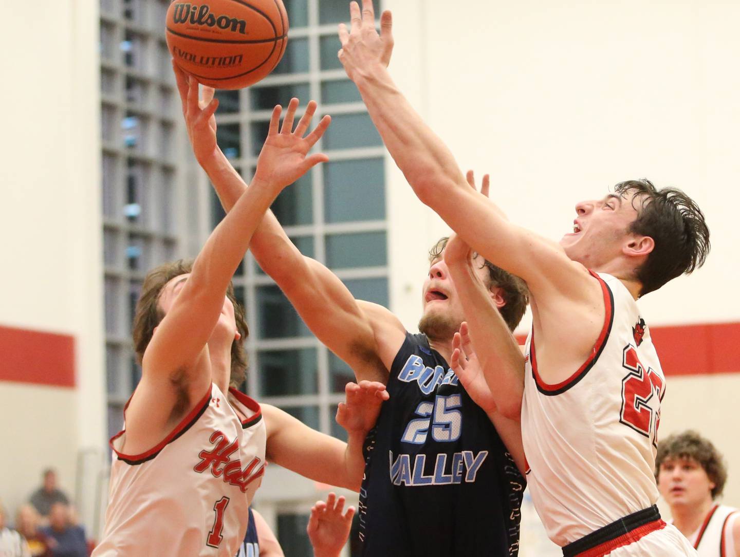 Bureau Valley's Landon Hulsing grabs a rebound over Hall's Joseph Bacidore and teammate Brayden Curran on Tuesday, Feb. 6, 2024 at Hall High School.