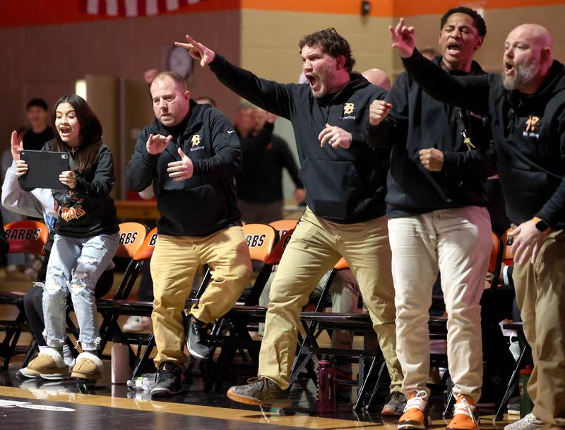 DeKalb coaches and wrestlers celebrate a win in one of the matches during their dual with Sycamore Friday, Jan. 17, 2025, during their match at DeKalb High School.