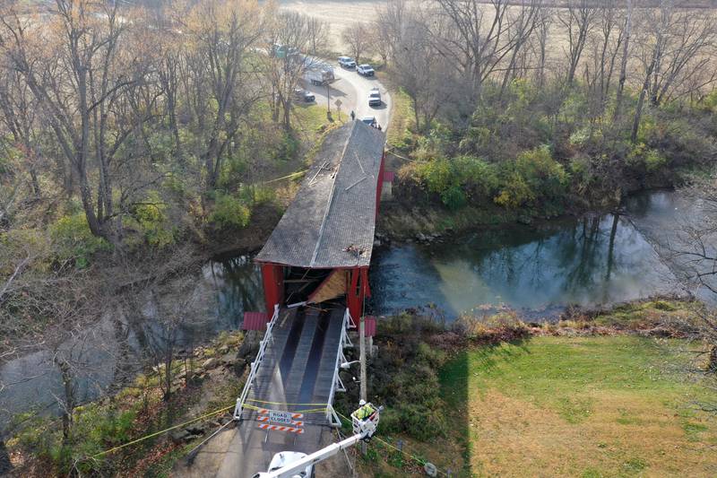 An aerial view of the damage of the Red Covered Bridge on Thursday, Nov. 16, 2023 in Princeton. Illinois Department of Transportation, Illinois State Police and Bureau County law enforcement survey the damage bridge after it was struck by a semi-truck.