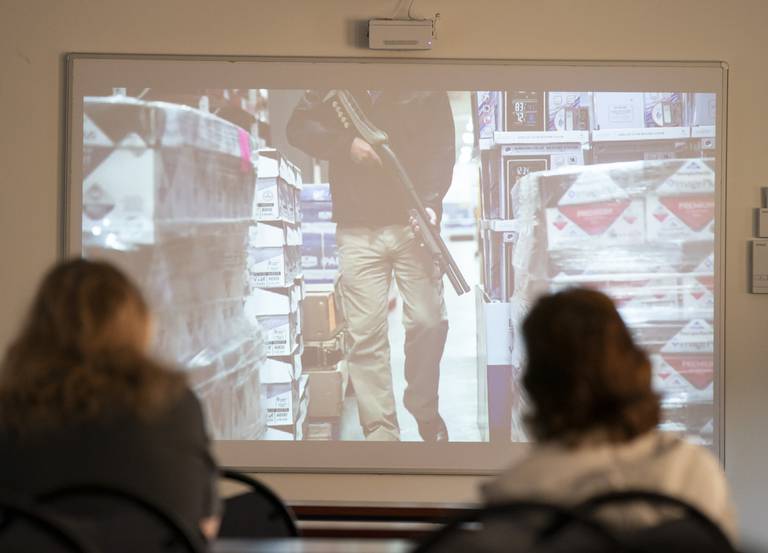 Students watch a video depicting an fake active shooter situation at a workplace during a Civilian Response to Active Shooter Events (CRASE) training held by the Lake in the Hills Police Department on Tuesday, Sept. 13, 2022, at the Safety Education Center in Lake in the Hills. Residents were taught how to prepare, prevent and react to a potential active shooter situation.